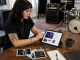 Independent bandleader assembling an electronic press kit in a rehearsal room