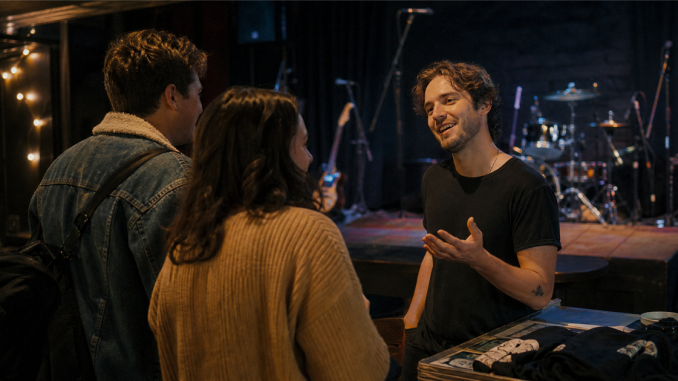 Independent musician talking with listeners after a small performance