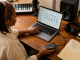 Independent musician organizing recording files and backups in a home studio