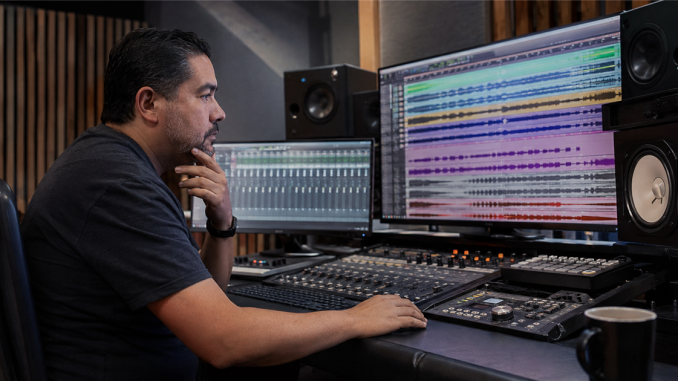 Producer reviewing aligned multitrack stems in a recording studio